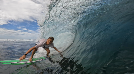 Boy surfing in a barrel