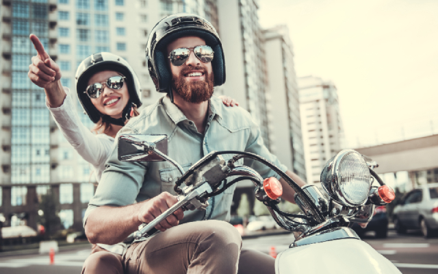 A male and female on a scooter