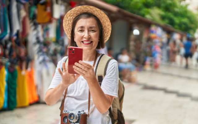 Single lady traveller with her phone and a camera around her neck. 