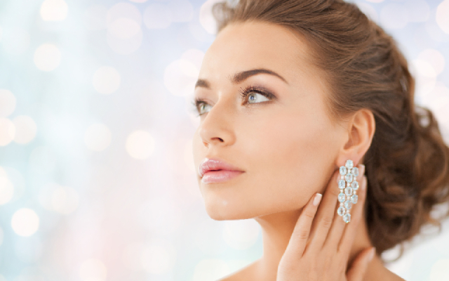 Lady posing with beautiful diamond like earrings