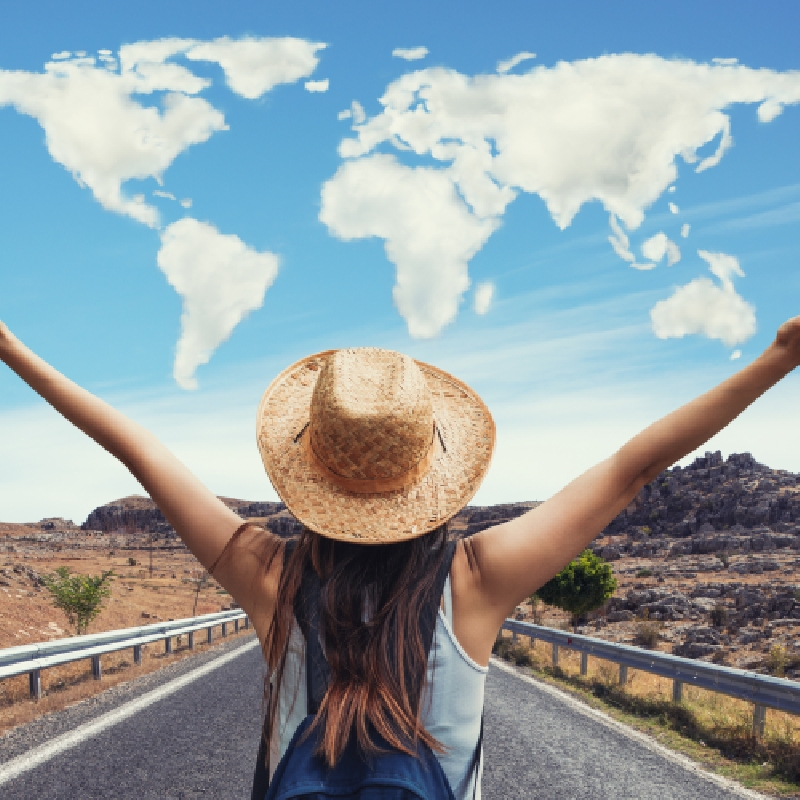 Woman looking at the sky which is a world map of clouds