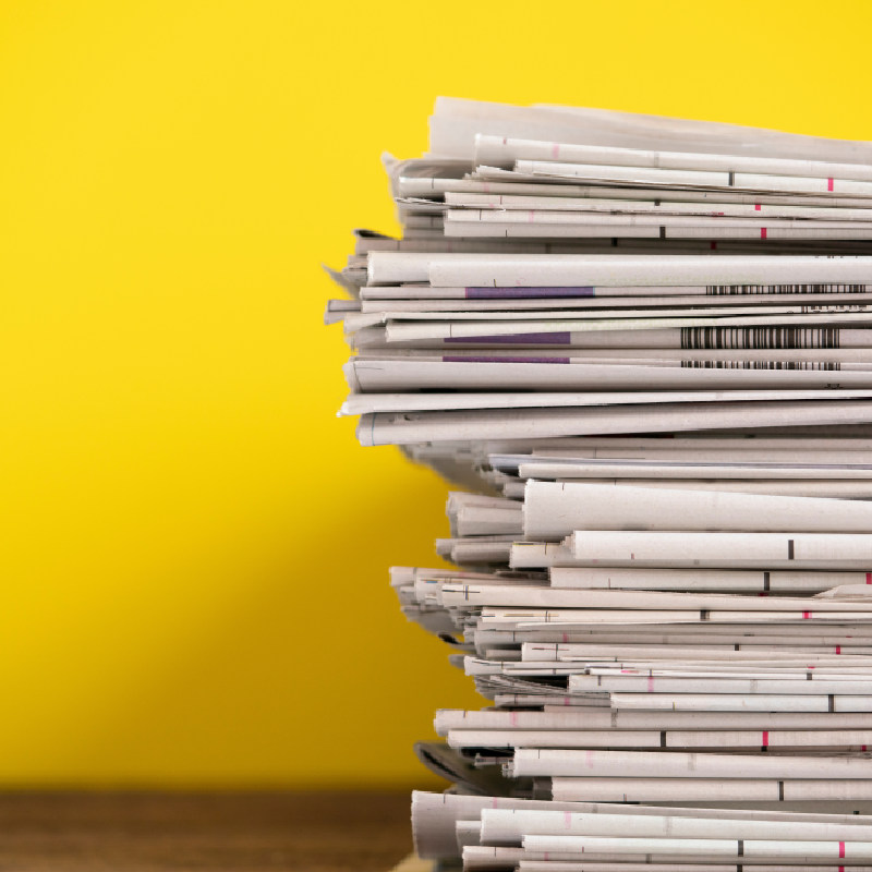 A stack of newspapers, a visual for the Press Release button