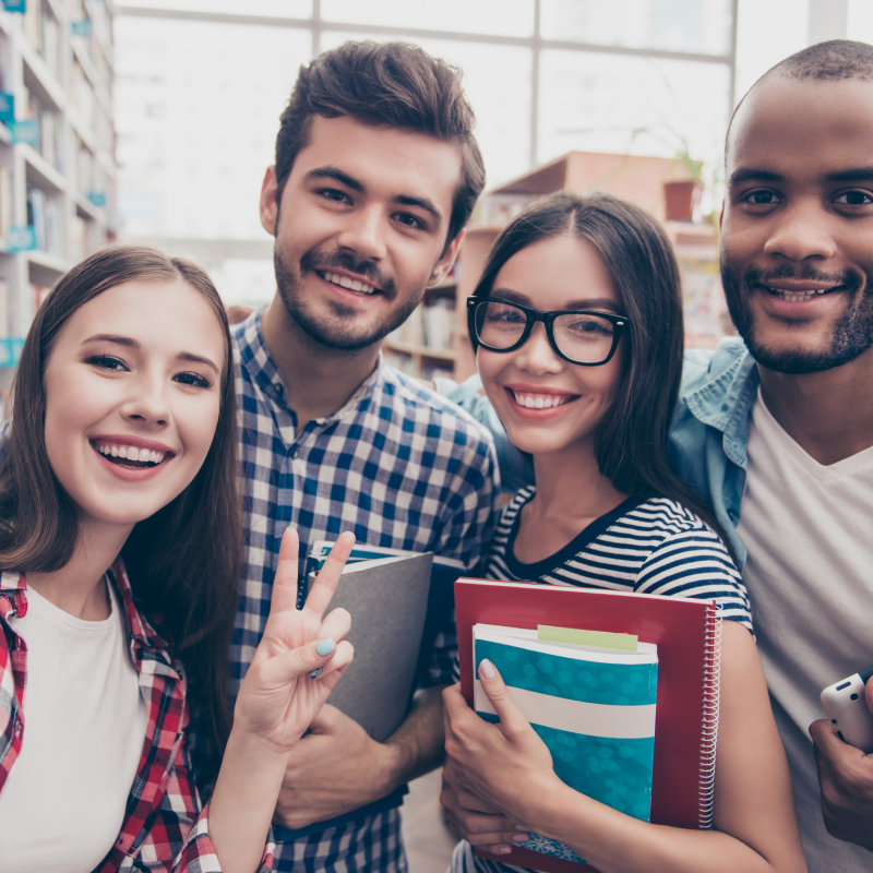 A picture of four international students smiling