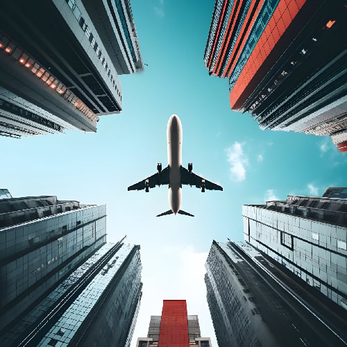 Plane in the sky between high rise buildings in a city